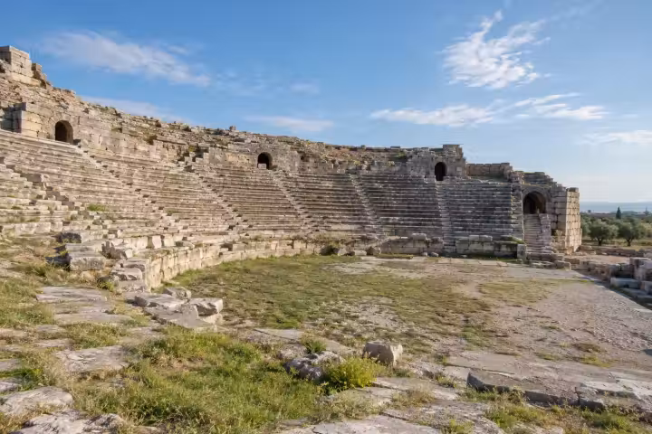 Curving ancient theatre seats and stone arches in the Miletos countryside