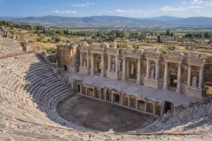 Curved stone seating and the carved stage facade of Hierapolis theatre near Pamukkale