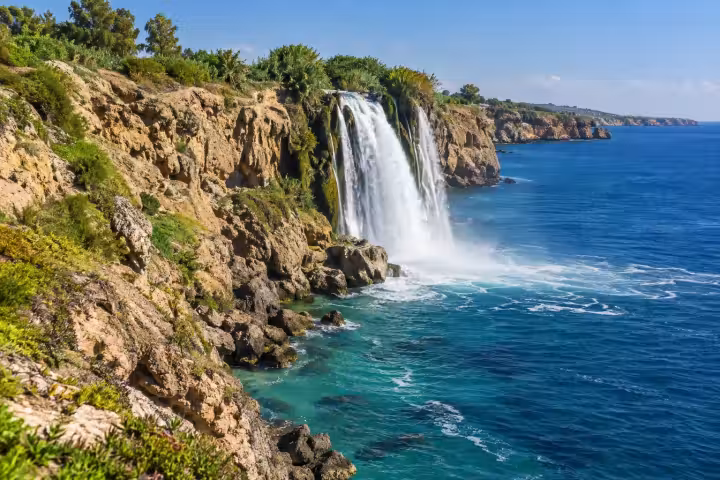 Lower Duden waterfall dropping from Antalya sea cliffs into the blue Mediterranean